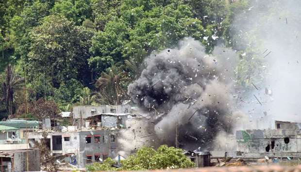 Debris and smoke are seen after an OV-10 Bronco aircraft released a bomb during an air strike, as government forces continue their assault against insurgents from the Maute group.