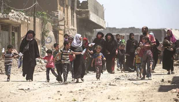 Civilians flee from the Old City of Mosul as Iraqi forces advance.