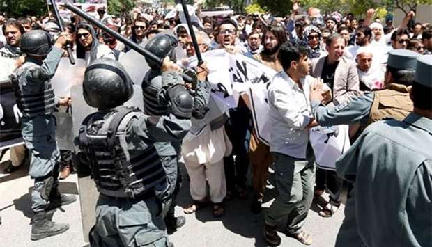 Afghan policemen clash with demonstrators during a protest in Kabul on Friday.