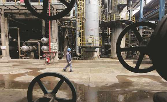A worker walks past oil pipes at a refinery in Wuhan, Hubei province. Fuel oil, the residue left over after initial crude refining, has become scarce in Asia as refiners make their plants more complex by upgrading it to change the fuel into gasoline and diesel.