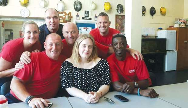 Singer Adele poses with firefighters at the Chelsea Fire Station. The singer paid an unexpected visit to the station, because she wanted to thank the firefighters who were involved with fighting the Grenfell Tower fire.