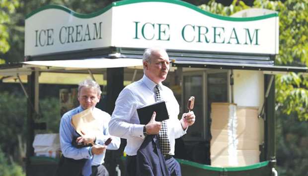 Two men buy ice cream in St Jamesu2019s Park in central London yesterday as temperatures across the country soared.