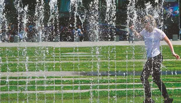 A girl cools off in a public fountain in Berlin.