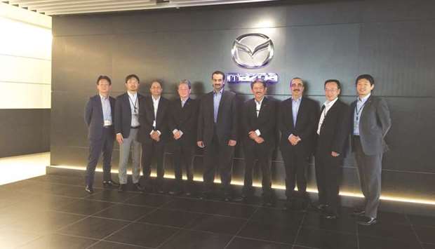 Sheikh Ahmad Nasser al-Thani is seen with Hiroshi Yoshida and other top Mazda officials at the Mazda headquarters in Hiroshima, Japan.