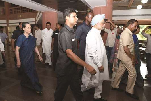 Congress chief Sonia Gandhi and former prime minister Manmohan Singh arrive to attend an all opposition party leaders meeting over presidential election at Parliament house library building in New Delhi yesterday.