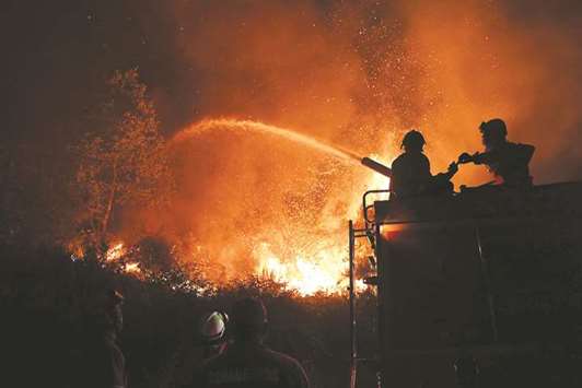 Firefighters try to extinguish a wildfire in Colmeal, near Gois, on Wednesday night.