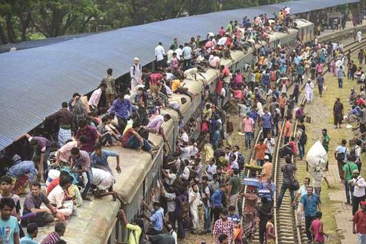 Bangladeshis cram onto a train as they travel home to be with their families ahead of Eid al-Fitr.