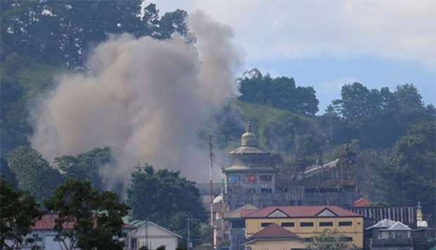 Smoke is seen after an OV-10 Bronco aircraft released a bomb during an airstrike, as government troops continue their assault against insurgents in Marawi city, Philippines on Friday.