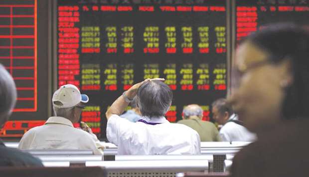 An investor reacts as he looks at screens showing stock market movements at a securities company in Beijing. The IPO booms and busts, fuelled by a mix of government intervention and unbridled speculation, are becoming more frequent in China as authorities accelerate approvals for newly listed shares.