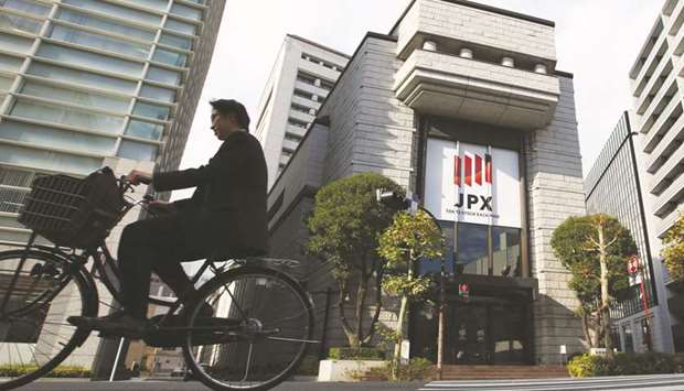 A man cycles past the Tokyo Stock Exchange building. As the Nikkei 225 Stock Average rises towards its highest level in more than two decades, one group of investors has surprisingly missed out.