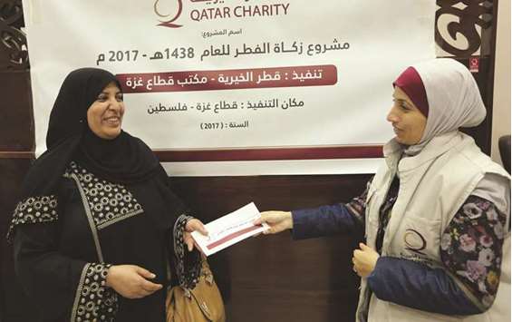 A woman receiving an aid packet from a QC volunteer.