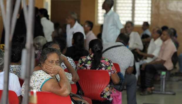 Sri Lankan patients wait for treatment at an empty government hospital in Colombo