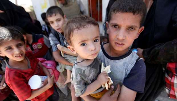 Displaced Iraqi children who fled from clashes are seen in the Old City of Mosul