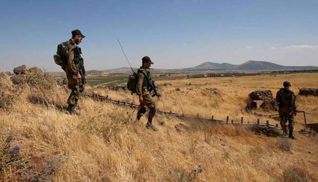 Israeli soldiers patrol near the border with Syria after projectiles fired from the war-torn country hit the Israeli occupied Golan Heights.