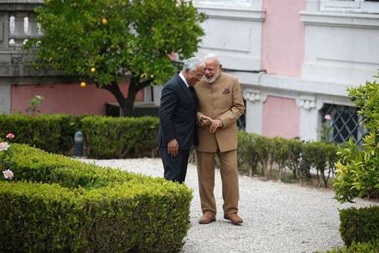 Prime Minister Narendra Modi and his Portuguese counterpart Antonio Costa share as light moment as they take walk at the Necessidades Palace in Lisbon yesterday.