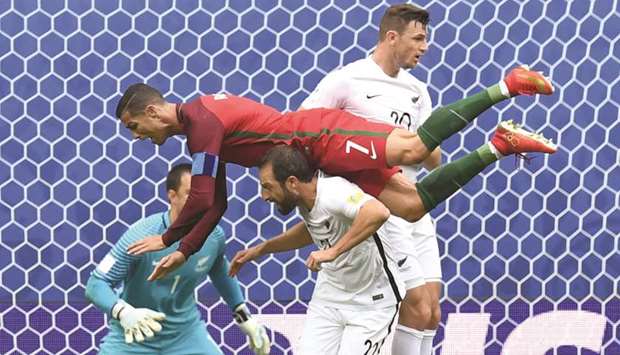 Portugalu2019s forward Cristiano Ronaldo falls over New Zealandu2019s defender Andrew Durante during the 2017 Confederations Cup group u2018Au2019 match at the Saint Petersburg Stadium in Saint Petersburg yesterday. (AFP)