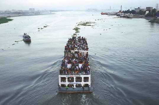A ferry with passengers travelling home to celebrate Eid al-Fitr festival leaves Dhaka yesterday.