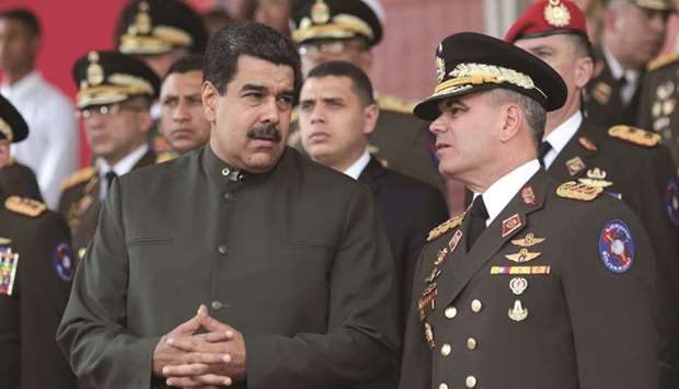 Maduro speaks with Defence Minister Vladimir Padrino Lopez during an event in Caracas.