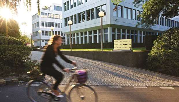 A cyclist rides past the entrance to Glencore headquarters in Baar, Switzerland. Glencore would pay $2.68bn in cash plus a coal-price linked royalty for the Coal & Allied unit in New South Wales, the company said in a statement on Friday.