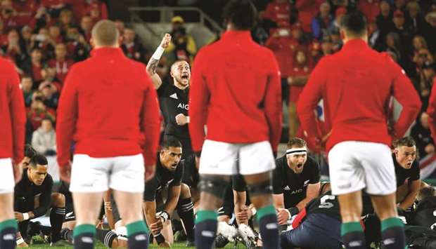 British and Irish Lions (in red and white) watch New Zealand perform the haka at Eden Park in Auckland yesterday. (Reuters)