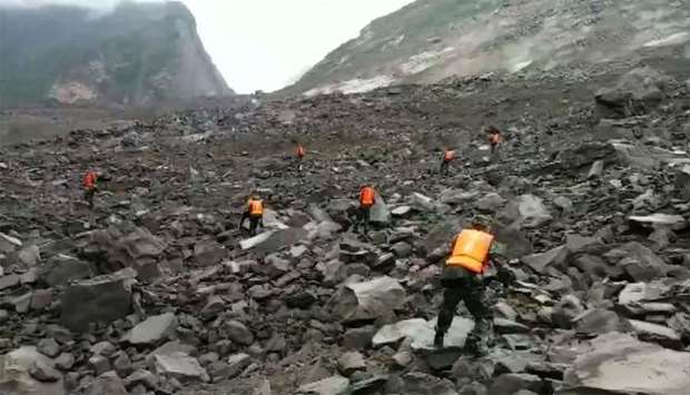 Rescuers looking for survivors after a landslide hit the village of Xinmo in China