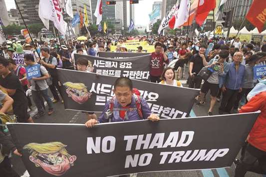 South Korean protesters march towards the US embassy in Seoul yesterday at a rally against the deployment of the THAAD system.
