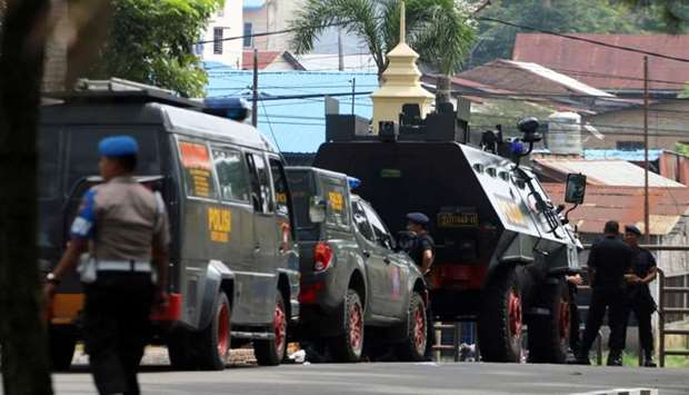 Police are seen near the scene of an attack on a post that left one officer dead in Medan