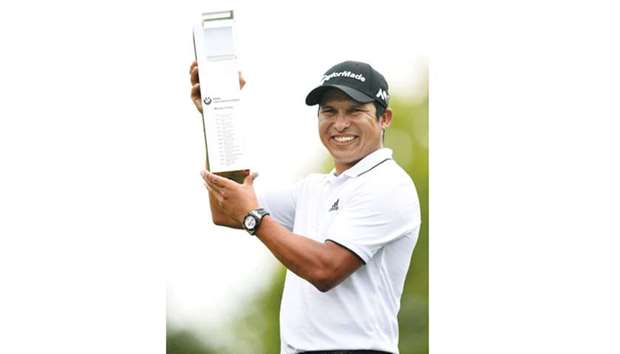 Andres Romero of Argentina smiles as he holds the trophy after winning the final of the BMW International Open golf tournament in Eichenried near Munich yesterday. (AFP)