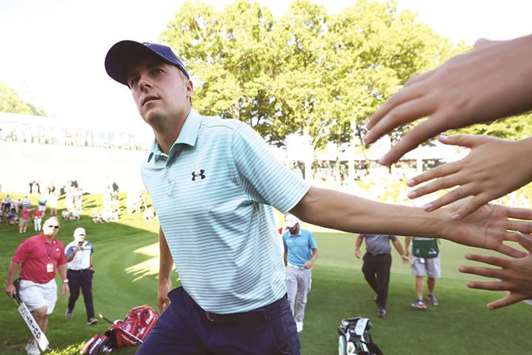 Jordan Spieth of the United States high fives fans after putting on the 18th green during the third round of the Travelers Championship at TPC River Highlands in Cromwell, Connecticut. (Getty Images/AFP)