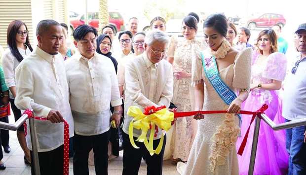 Philippine ambassador Alan L Timbayan leads the ribbon-cutting ceremony of the 119th Philippine Independence Day celebration. Also seen are (from left) Fos, labour attache David Des T Dicang, and Mutya ng Pilipinas Tourism International 2016 winner Jaya San Jose.