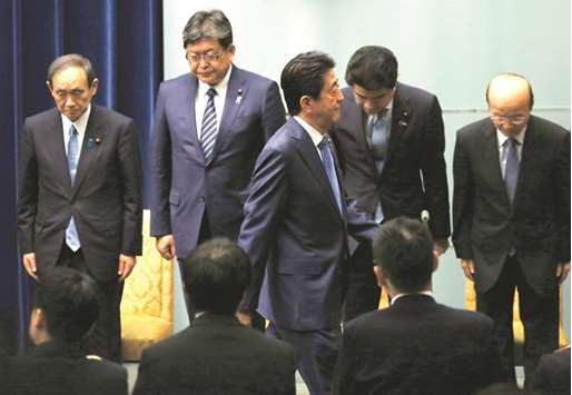 Japanu2019s Prime Minister Shinzo Abe (centre) leaves a news conference at his official residence in Tokyo. Abe said he wants to reach a basic free trade agreement with the EU next month.