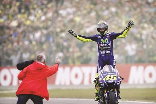 Italyu2019s Valentino Rossi celebrates after winning the Assen Motorcycling Grand Prix at the TT circuit in Assen, Netherlands, yesterday.
