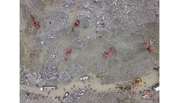 Chinese rescuers search for survivors at a landslide area in the village of Xinmo.