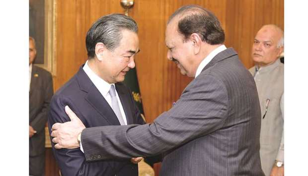 Pakistan President Mamnoon Hussain shakes hands with Chinese Foreign Minister Wang Yi upon his arrival at President House in Islamabad yesterday.