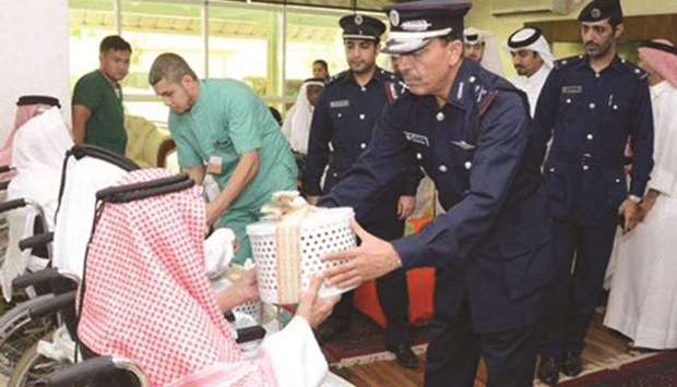 HE the Director General of Public Security at the Ministry of Interior Major General Saad bin Jassim al-Khulaifi giving gifts to the elderly at the Ehsan Centre for Empowerment and Elderly Care yesterday on the occasion of Eid al-Fitr.