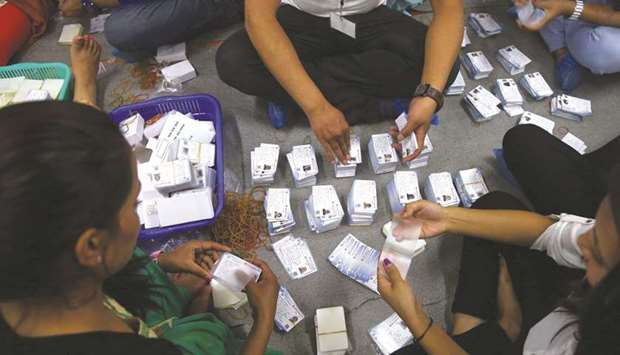 Officials prepare votersu2019 identity cards for the upcoming election in Kathmandu yesterday.