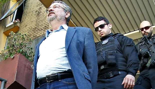 Antonio Palocci, a former Brazilian finance minister,  arriving under police escort