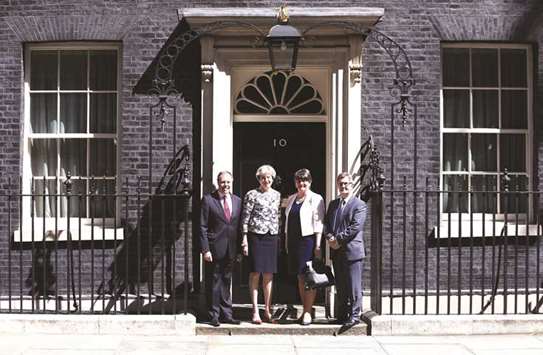 Prime Minister, Theresa May, poses for a photograph with Democratic Unionist Party (DUP) leader Arlene Foster, deputy leader Nigel Dodds, and chief whip Jeffrey Donaldson, outside 10 Downing Street, in central London yesterday.
