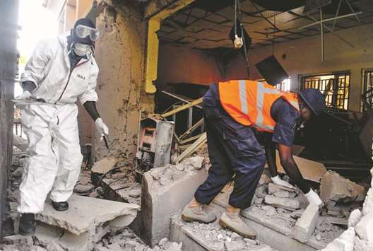 Emergency personnel work at the site of a blast at the campus of Maiduguri University.