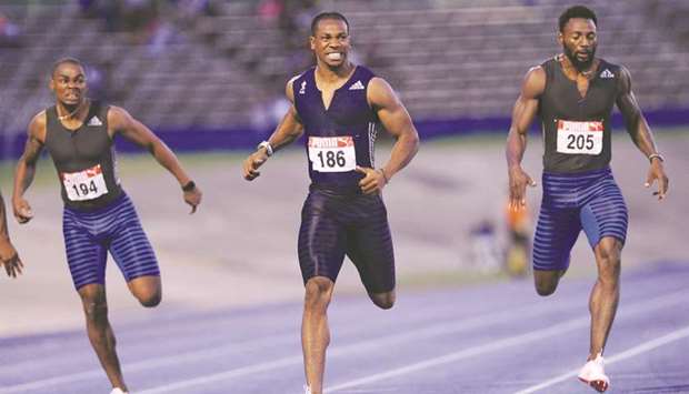 (Left to right) Warren Weir, Yohan Blake and Rasheed Dwyer at the 200m finish line in Kingston. Blake won the race in 19.97s. (AFP)