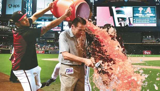 Arizona Diamondbacks left fielder Daniel Descalso (right) gets a Gatorade bath from teammates after a walk off single in the eleventh inning against the Philadelphia Phillies. PICTURE: USA TODAY Sports