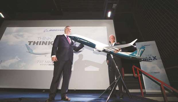 Kevin McAllister, CEO of commercial-airplanes at Boeing Co (left), and Dennis Muilenburg, chief executive officer, pose beside a model of a Boeing 737 Max 10 passenger jet during a news conference at the 53rd International Paris Air Show at Le Bourget in Paris. Boeing has signalled a determination to win back market share with a combative new style, swapping traits with an unusually sombre Airbus after winning the Paris Airshow with a slick launch for its new 737 Max 10 jet.