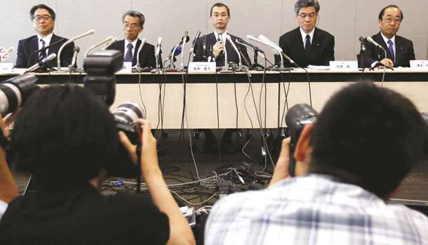 Takata chairman and CEO Shigehisa Takada (centre), company senior officials and lawyers attend a news conference after the companyu2019s decision to file for bankruptcy protection in Tokyo yesterday. The companyu2019s total liabilities stand at u00a51.7tn ($15bn), Tokyo Shoko Research estimated.
