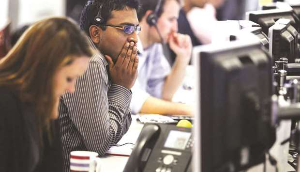 A dealer reacts to share movements on the trading floor at financial spread betting company IG Index in the City of London (file). If fund managers want to keep trading in European dark pools, they will need a big overhaul of their practices before new rules kick in next year.