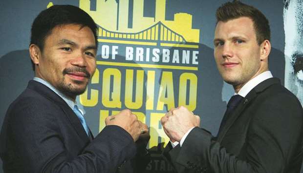 This file photo taken on April 26, 2017 shows World Boxing Organization (WBO) welterweight defending champion Manny Pacquiao (L) of the Philippines posing for pictures with Australian contender Jeff Horn (R) during a promotional press conference at Suncorp Stadium in Brisbane.