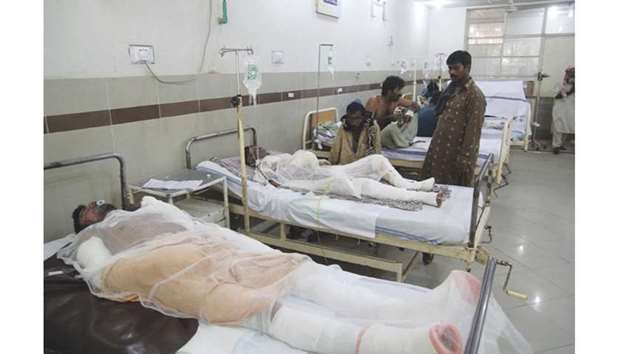 Pakistani burn victims are treated at a hospital in Bahawalpur, after oil tanker after caught fire following an accident on a highway near the town of Ahmedpur East, some 670km.