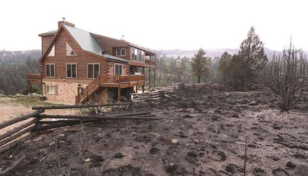 The wildfire burned up to the the edge of a home but left it standing outside Panguitch, Utah.
