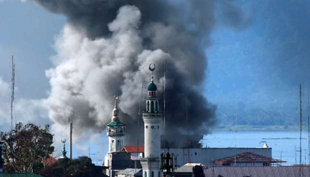 An explosion is seen after a Philippines army aircraft released a bomb during an airstrike as government troops continue their assault against insurgents from the Maute group in Marawi city.