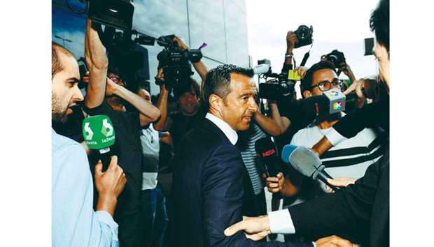 Football agent Jorge Mendes (centre) is surrounded by journalists as he arrives at the Court in Pozuelo de Alarcon in Madrid yesterday, to be questioned by Spanish judge as part of a probe into Colombian striker Radamel Falcaou2019s alleged tax evasion. (AFP)