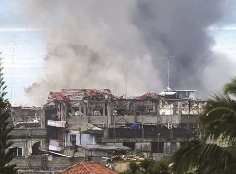 Black smoke billows from burning houses after an aerial bombing by the Philippine Air Force on militant positions in Marawi on the southern island of Mindanao yesterday.